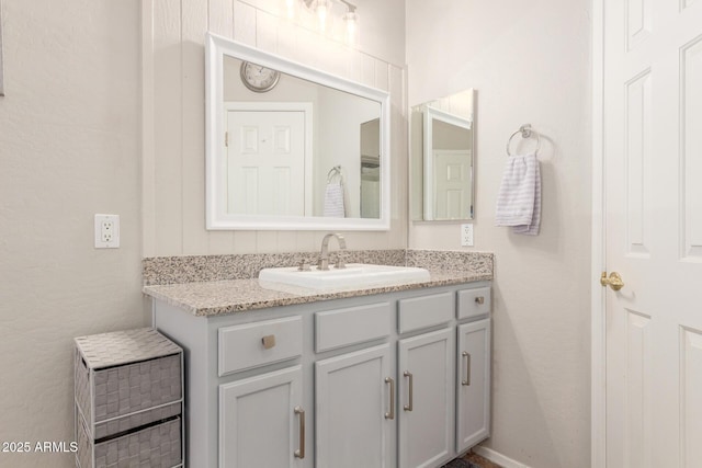 bathroom with vanity and baseboards