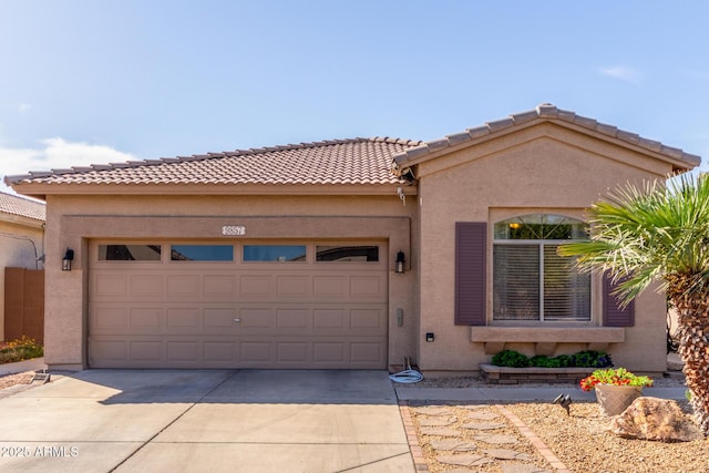 view of front facade featuring stucco siding, driveway, a tile roof, and a garage