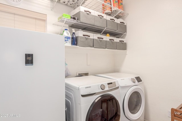 clothes washing area featuring laundry area and washer and dryer