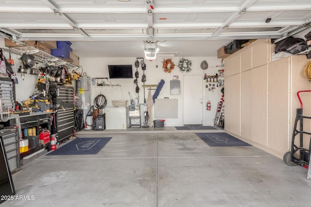 garage featuring water heater, a workshop area, and a garage door opener