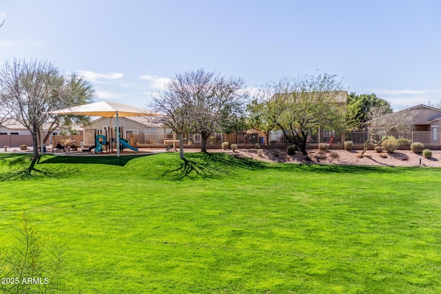 view of yard featuring a playground and fence