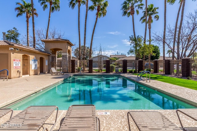 pool featuring a patio and fence