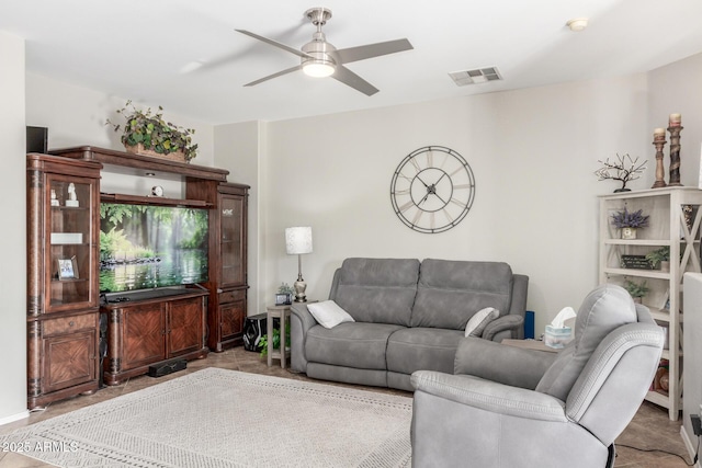 living area with visible vents and ceiling fan