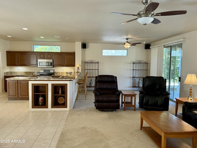 carpeted living room featuring ceiling fan