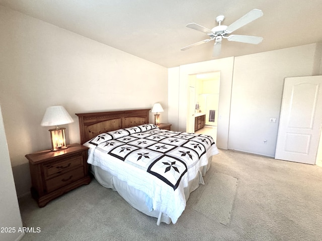 bedroom featuring ceiling fan, ensuite bathroom, and light carpet