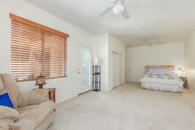 bedroom featuring ceiling fan, a closet, and light colored carpet