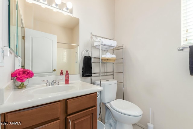 bathroom featuring walk in shower, vanity, and toilet