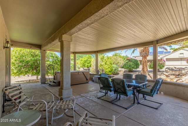 view of patio / terrace with a hot tub