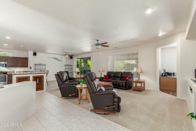 living room featuring ceiling fan and light colored carpet