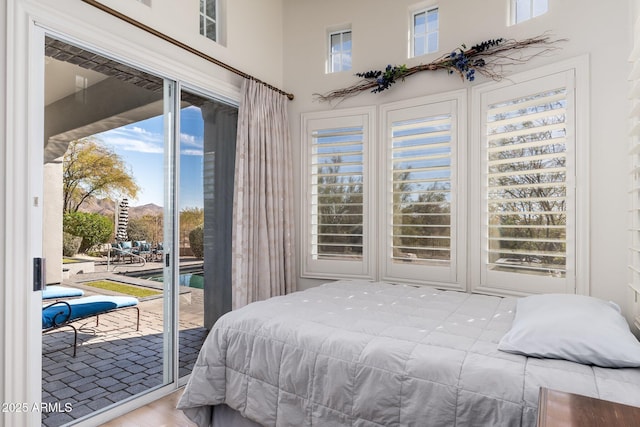 bedroom featuring access to outside, wood finished floors, and visible vents