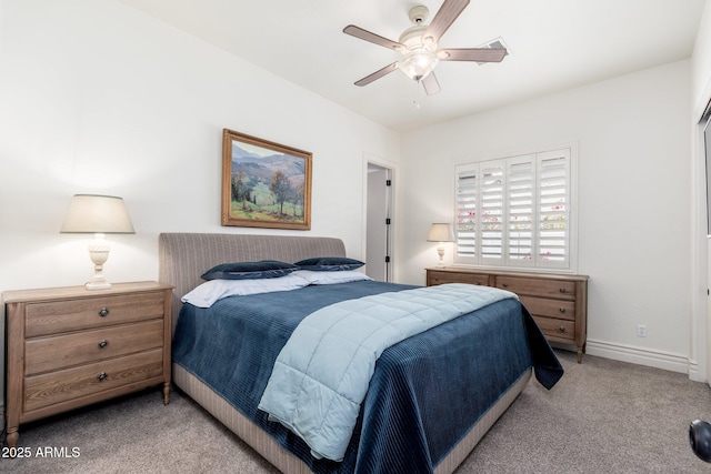 bedroom featuring light colored carpet, ceiling fan, and baseboards