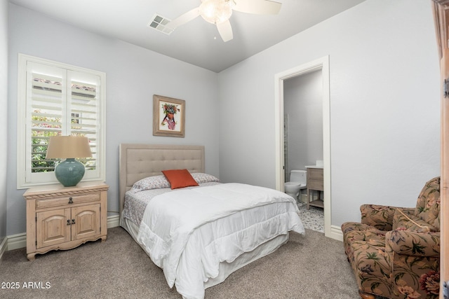 bedroom featuring baseboards, visible vents, a ceiling fan, light colored carpet, and ensuite bathroom