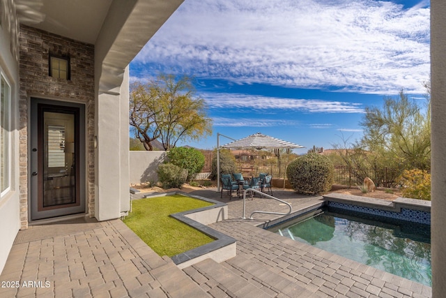 view of swimming pool featuring a patio area and a fenced backyard