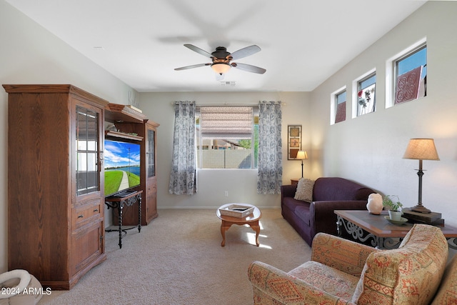 living room featuring light carpet and ceiling fan