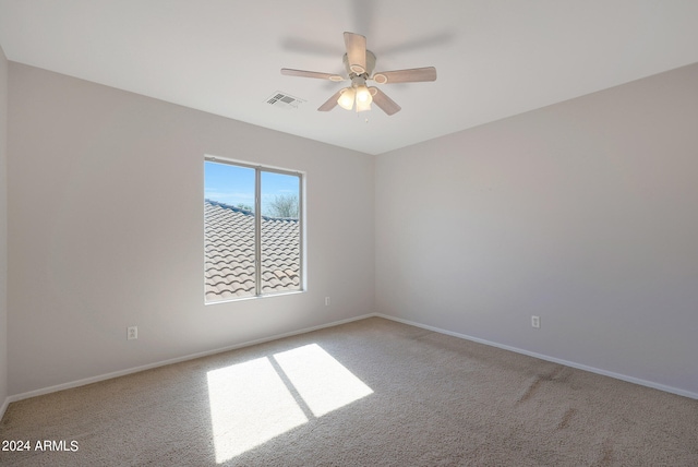 empty room featuring light carpet and ceiling fan