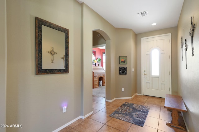 entryway with light tile patterned flooring