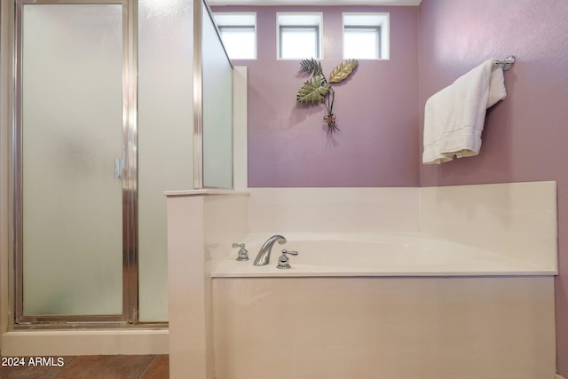 bathroom featuring tile patterned flooring and shower with separate bathtub