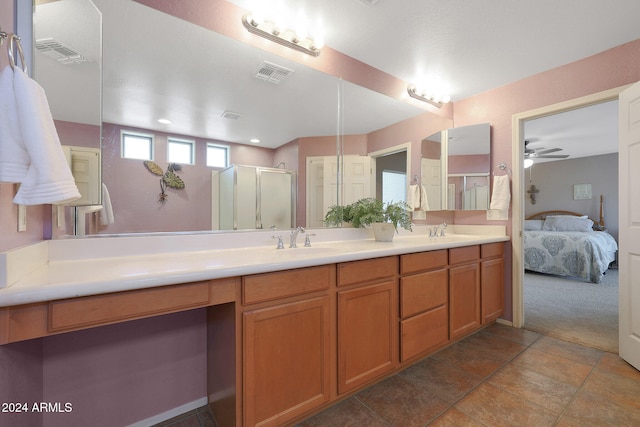 bathroom featuring a shower with shower door, vanity, and ceiling fan