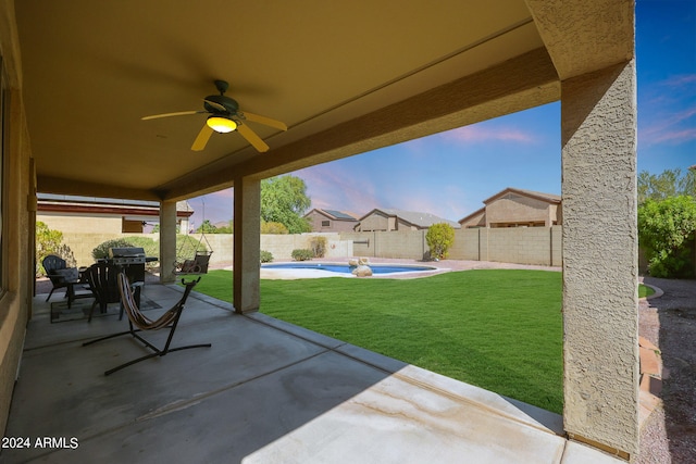 view of patio / terrace featuring ceiling fan and a fenced in pool