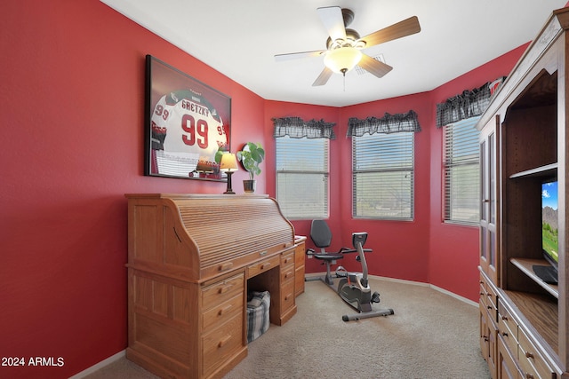 carpeted office space with ceiling fan