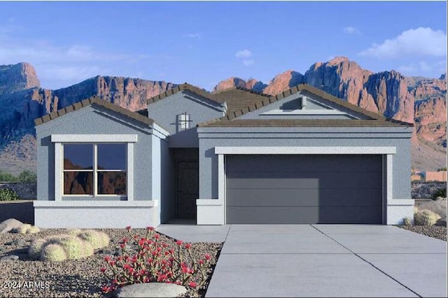 view of front of property with a garage and a mountain view