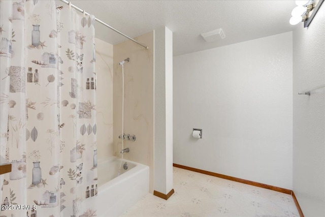 bathroom featuring shower / tub combo with curtain, baseboards, a textured ceiling, and tile patterned floors