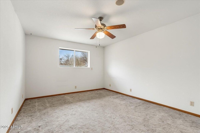 unfurnished room featuring a ceiling fan, carpet flooring, and baseboards