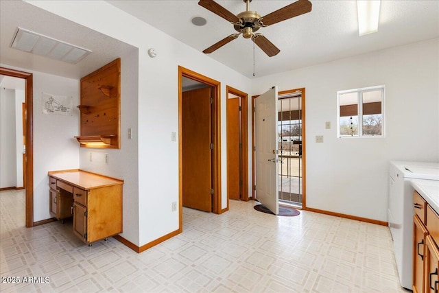 kitchen featuring visible vents, baseboards, light countertops, light floors, and washing machine and clothes dryer