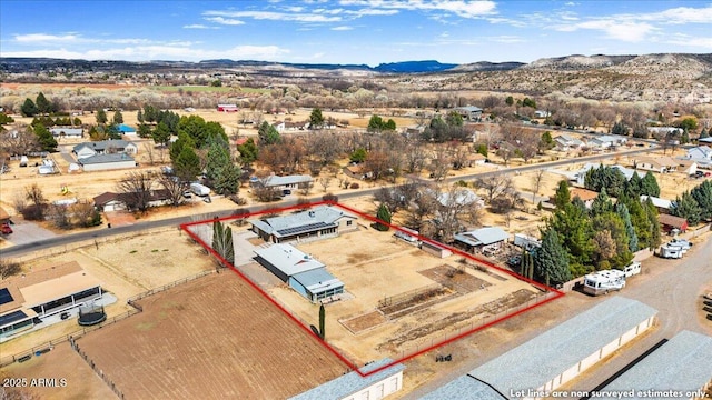 birds eye view of property with a mountain view