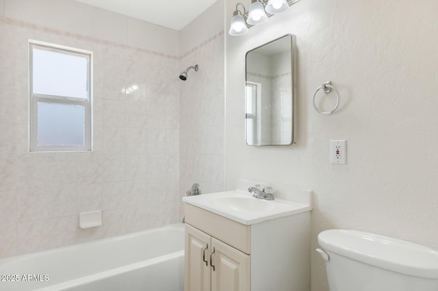 full bathroom with plenty of natural light, bathing tub / shower combination, vanity, and toilet