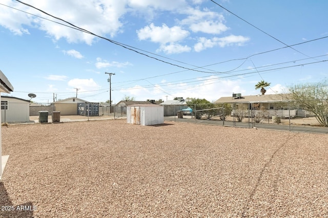 view of yard featuring an outbuilding and fence