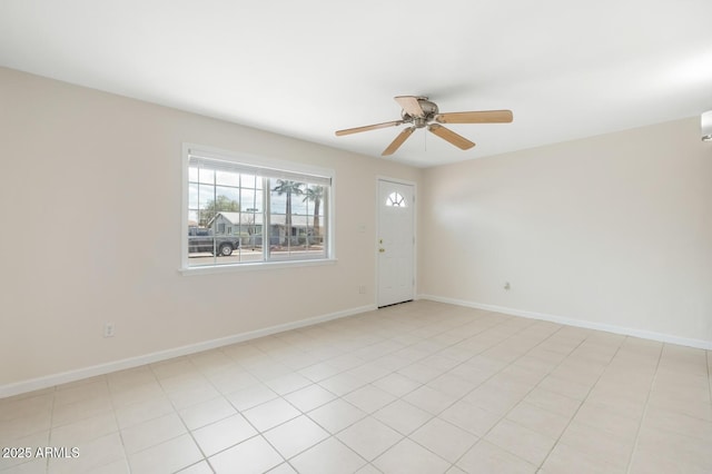 spare room featuring baseboards and a ceiling fan