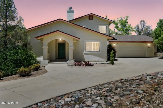 1405 Eagle Ridge Rd, Prescott, AZ 86301 - view of front of home featuring stucco siding, concrete driveway, an attached garage, and a chimney