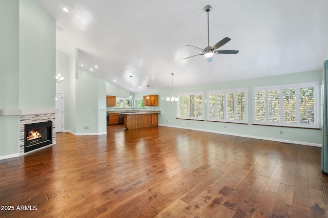 1405 Eagle Ridge Rd, Prescott, AZ 86301 - unfurnished living room with a chandelier, a ceiling fan, a fireplace, wood finished floors, and high vaulted ceiling