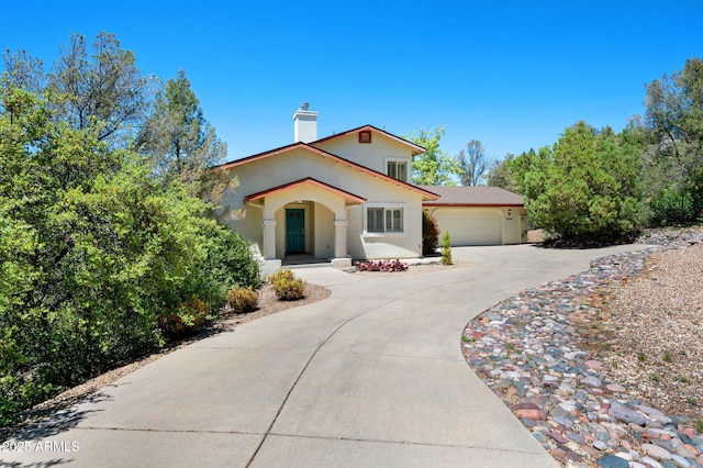 1405 Eagle Ridge Rd, Prescott, AZ 86301 - mediterranean / spanish house with concrete driveway, stucco siding, a chimney, and a garage