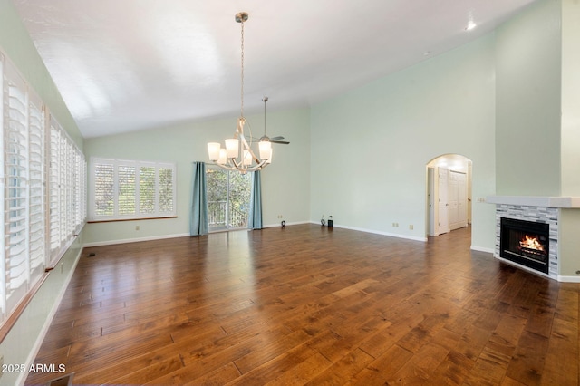 1405 Eagle Ridge Rd, Prescott, AZ 86301 - unfurnished living room with a chandelier, hardwood / wood-style floors, a stone fireplace, baseboards, and high vaulted ceiling