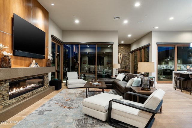 living room with a fireplace and light hardwood / wood-style floors