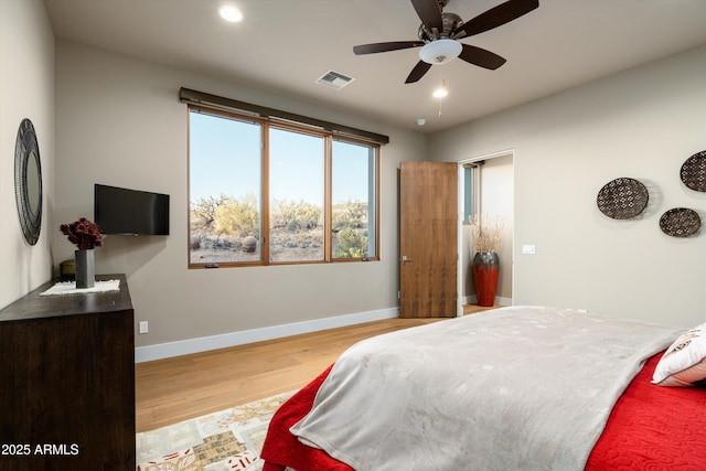 bedroom with ceiling fan and light hardwood / wood-style flooring