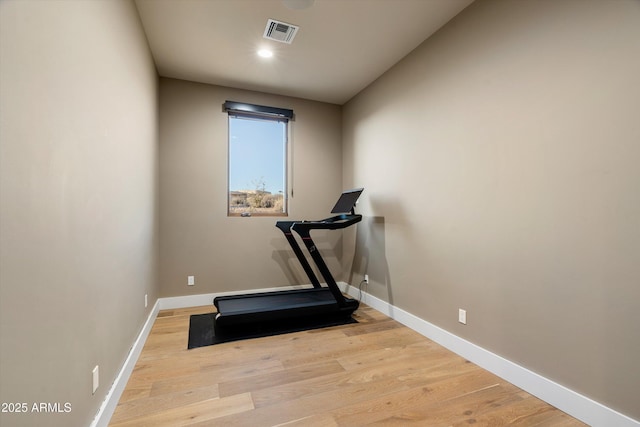 workout room with light hardwood / wood-style flooring