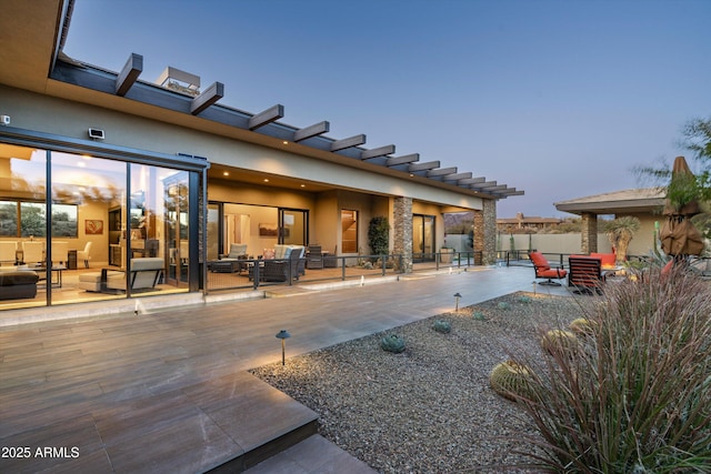 patio terrace at dusk featuring an outdoor living space