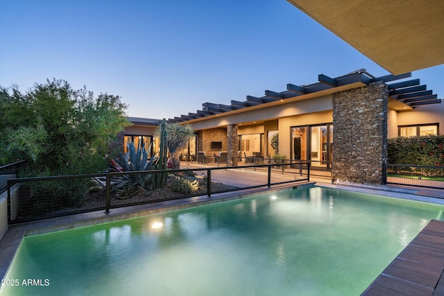 pool at dusk with a patio