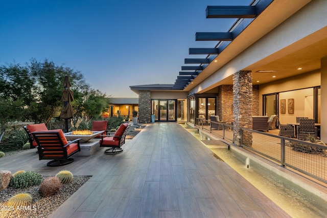 exterior space with an outdoor living space with a fire pit