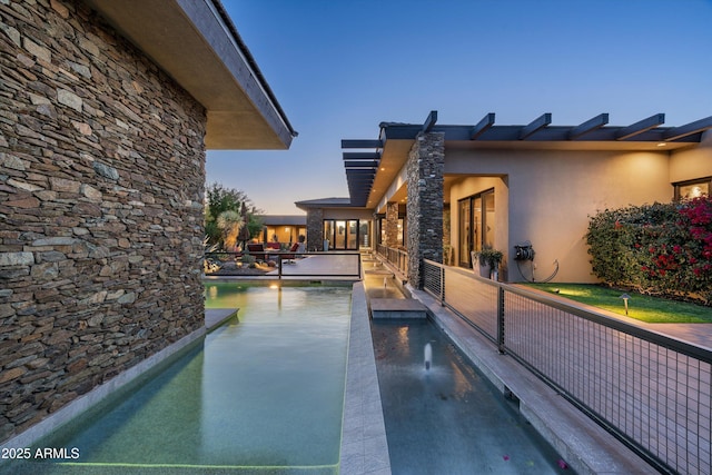 view of pool at dusk