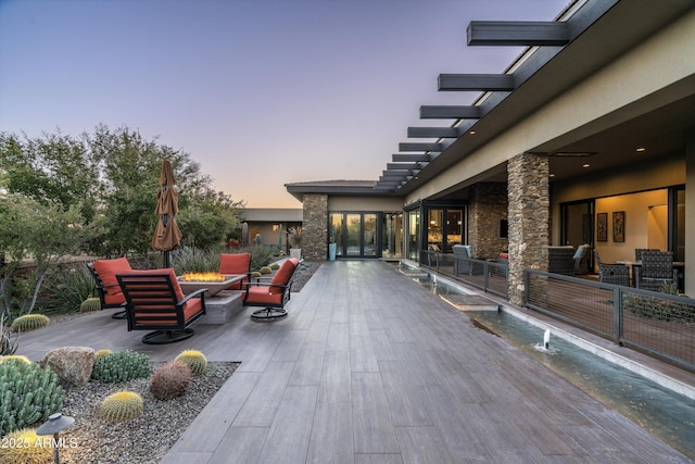 view of patio terrace at dusk