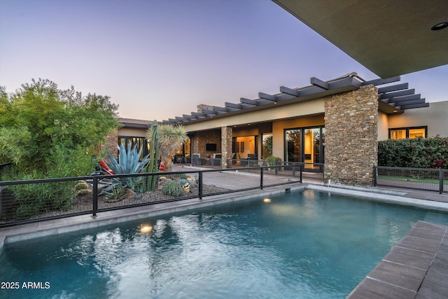 pool at dusk featuring a patio