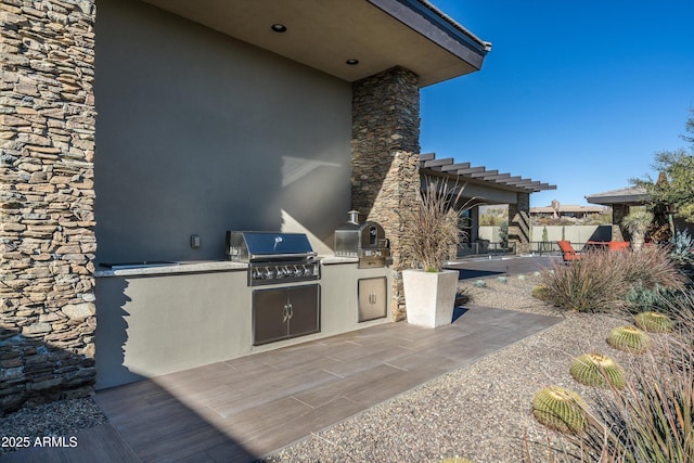 view of patio / terrace with area for grilling and a grill