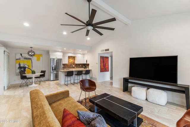 living area featuring lofted ceiling with beams, recessed lighting, visible vents, baseboards, and a ceiling fan