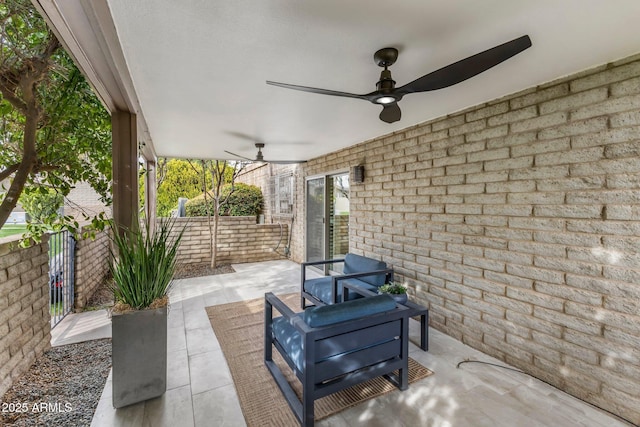 view of patio featuring fence and a ceiling fan