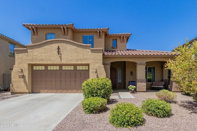 mediterranean / spanish-style home with a garage