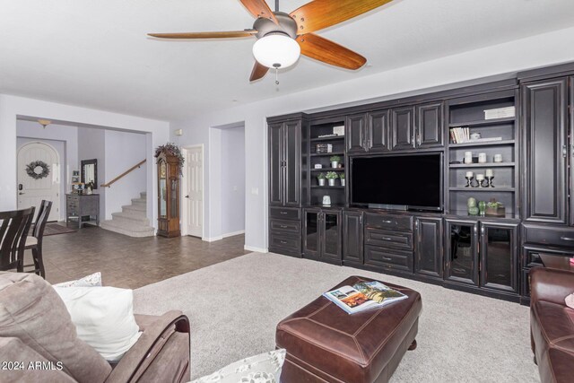 living room with ceiling fan and dark carpet